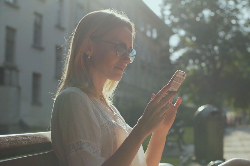 image of someone looking at their phone. Video - Are Wi-Fi Thermostats Cost-Effective? - Haynes Heating & Air Conditioning.