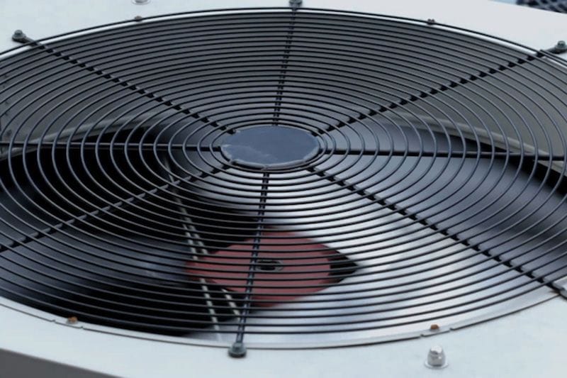 Video - The Importance of Air Conditioner Maintenance. Image is a magnified photograph of an AC unit.